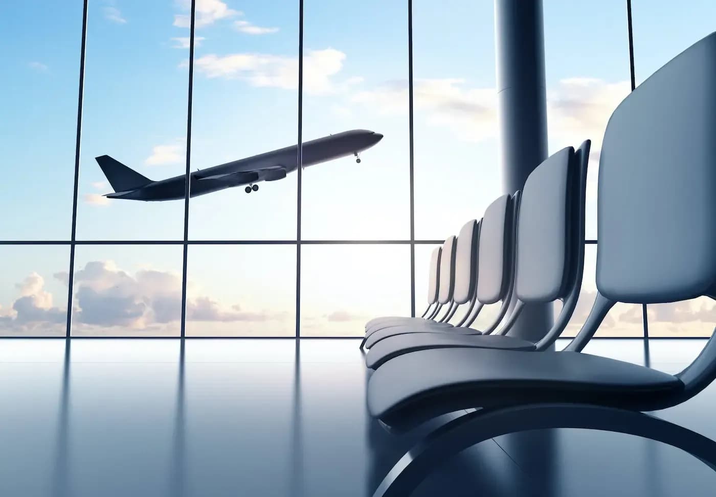 Empty airport lounge seats with airplane taking off visible through large windows