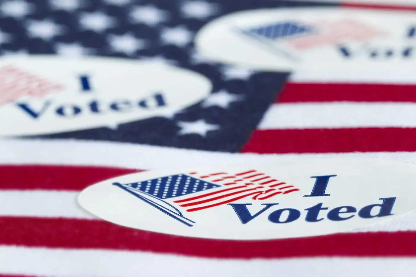 I Voted sticker with American flag on patriotic background