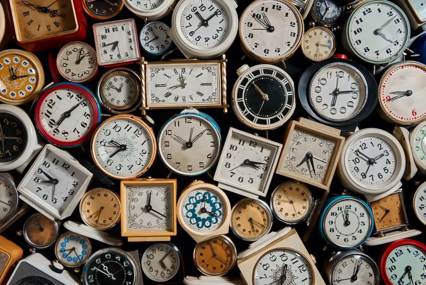 Collection of various vintage and antique clocks displaying different times