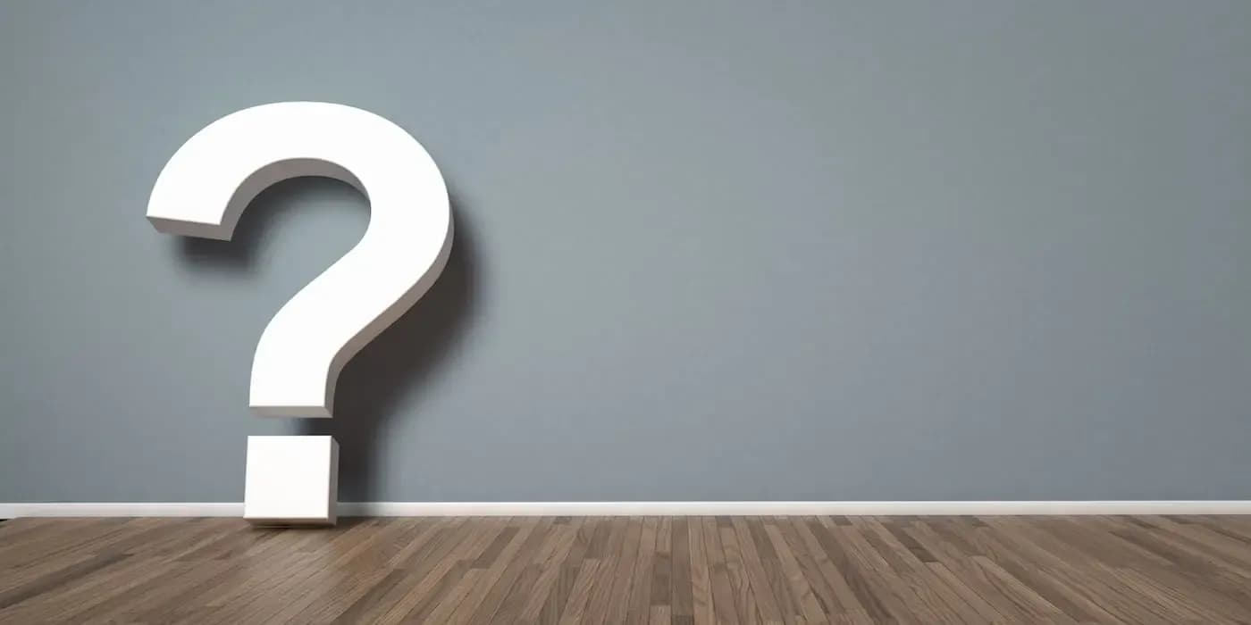 Large white question mark against gray wall with wooden floor, symbolizing legal inquiries
