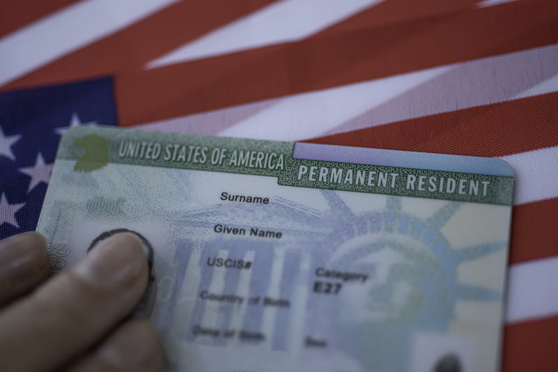 Permanent Resident Green card  of United states of America on flag of USA